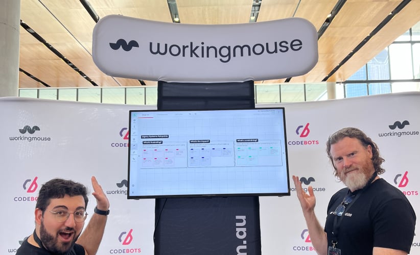Two WorkingMouse team members infront of the WorkingMouse stall at the Biig Convention
