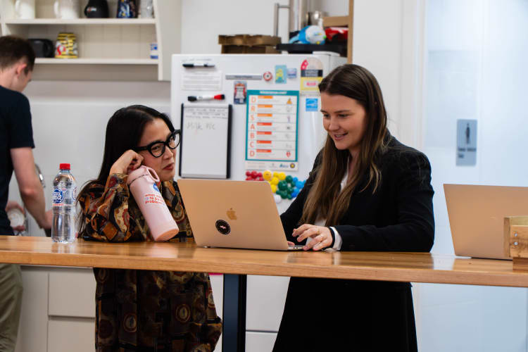 Two woman working on a laptop