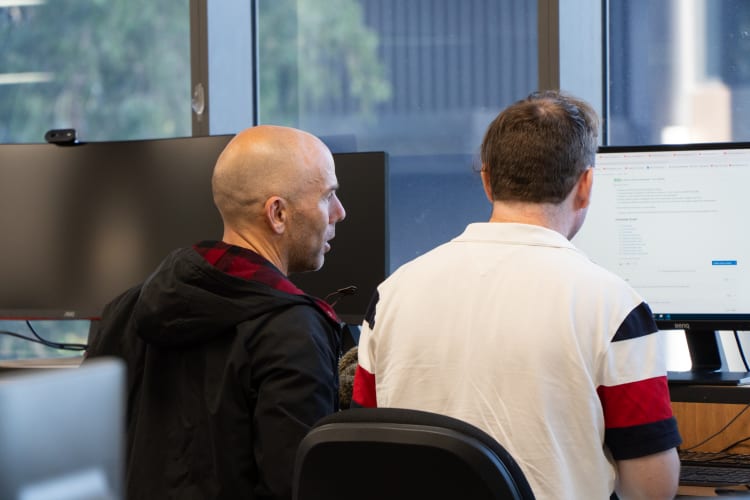 Two men looking at a computer screen